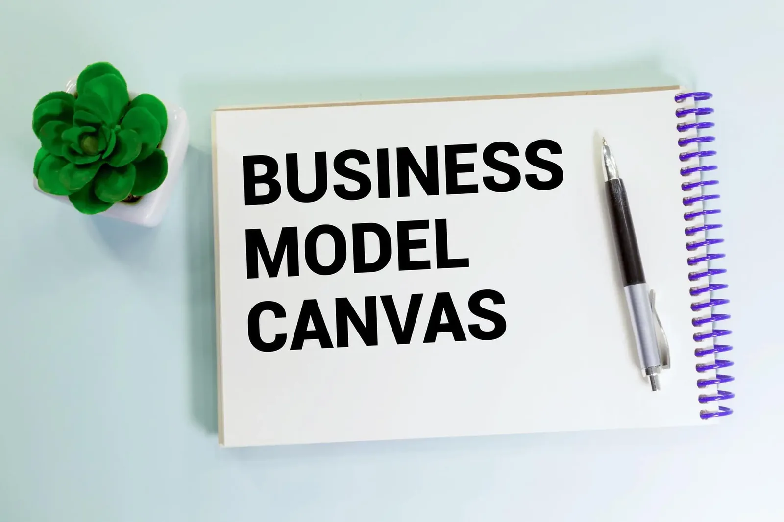 Business Model Canvas Paper ship and sheet on a gray background